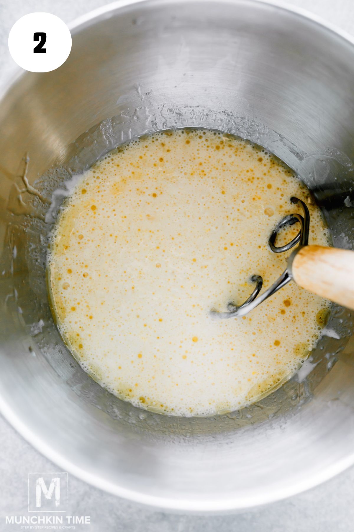 In a large bowl or the bowl of a stand mixer, mixed starter, water, oil, sugar, and egg.