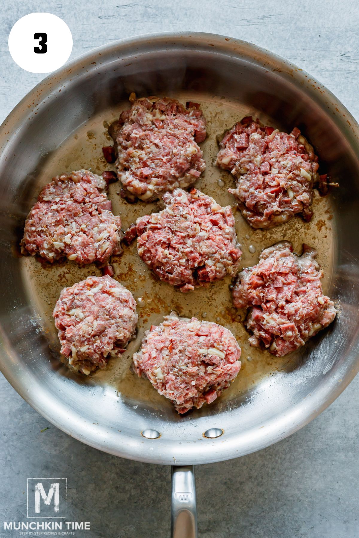 mini patties cooking in the skillet.
