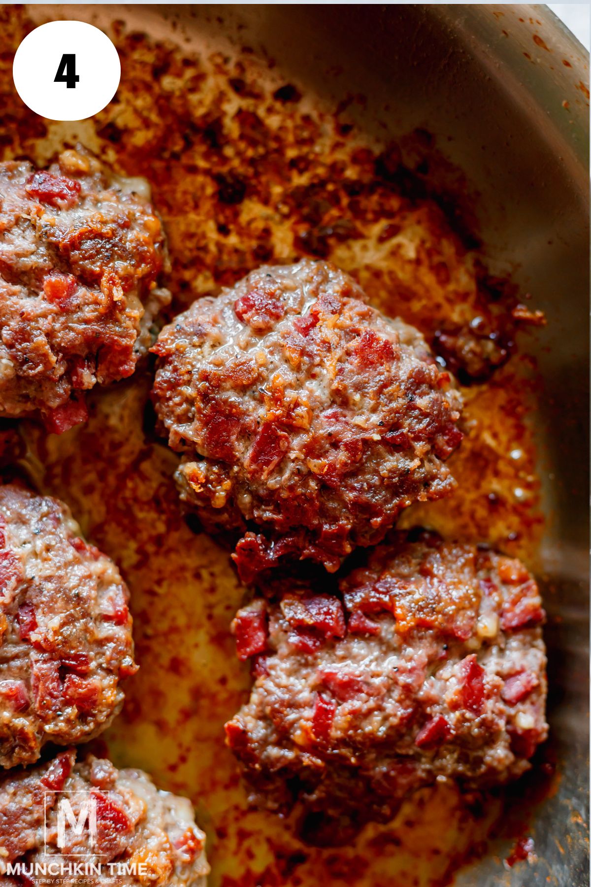 cooked ground beef patties in the skillet.