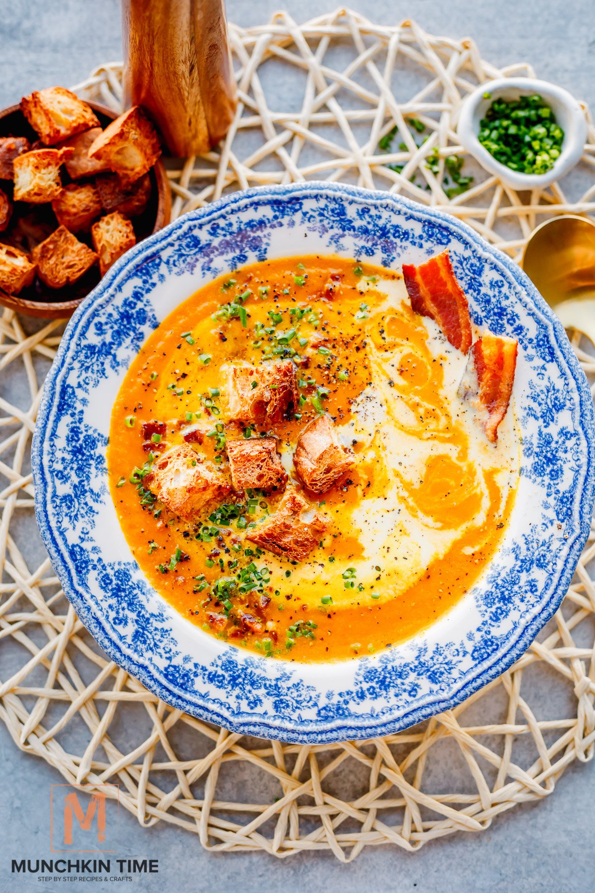 Creamy Carrot Soup garnish with croutons chives and cream.