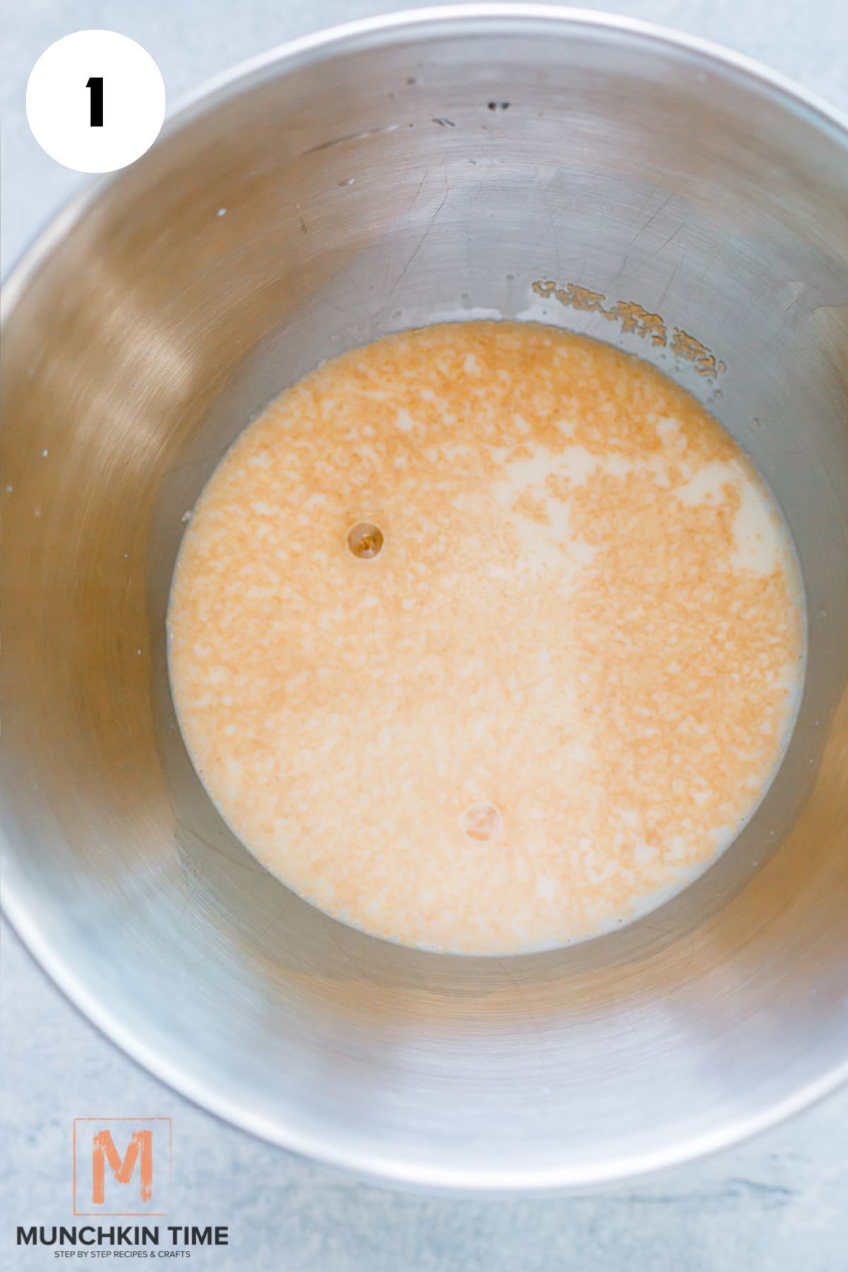 in a mixing bowl milk and yeast.