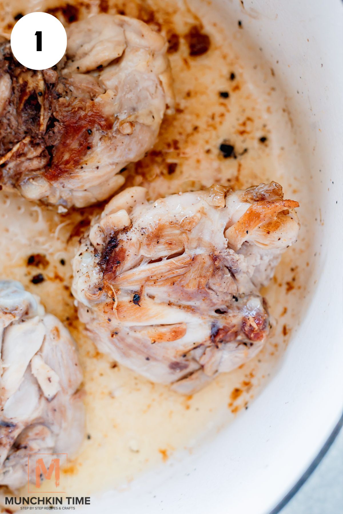 chicken thighs browning in the pot.