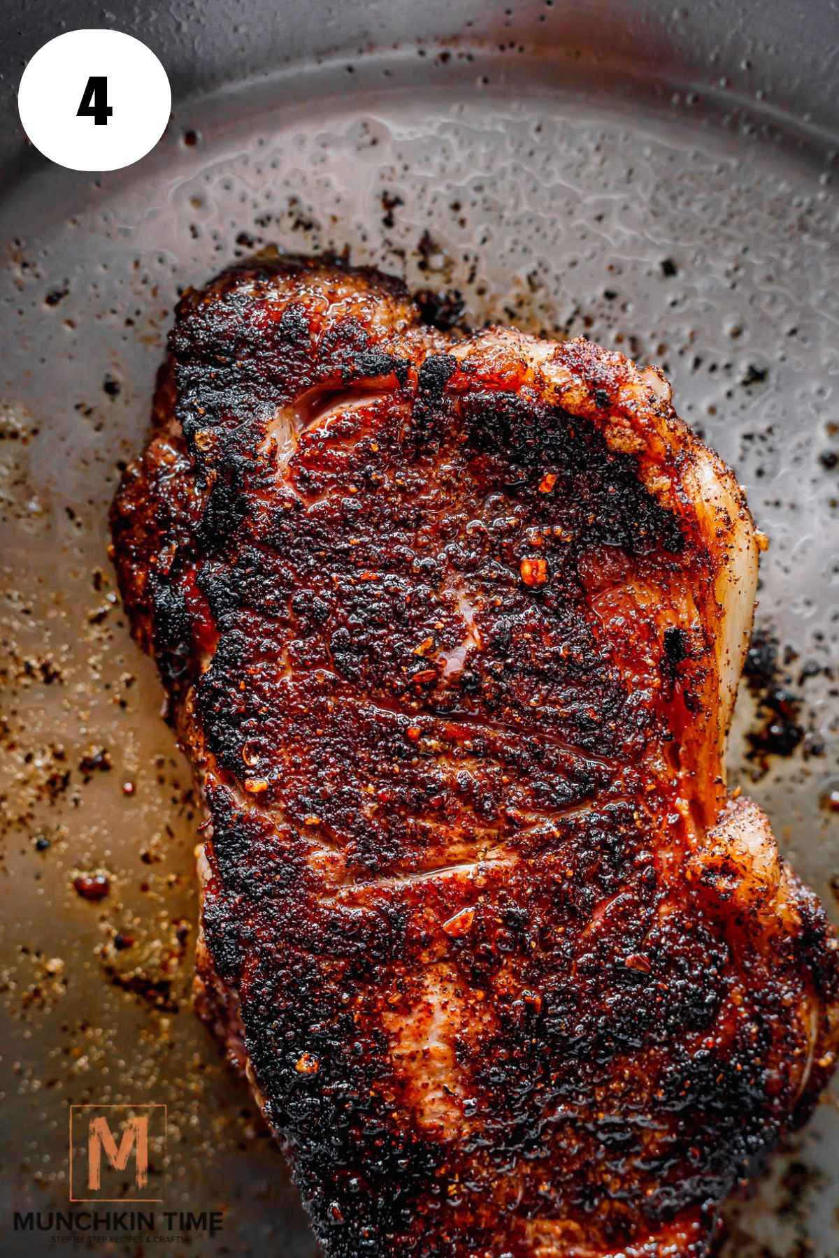 steak rubbed with coffee finished cooking in the stainless steel skillet.