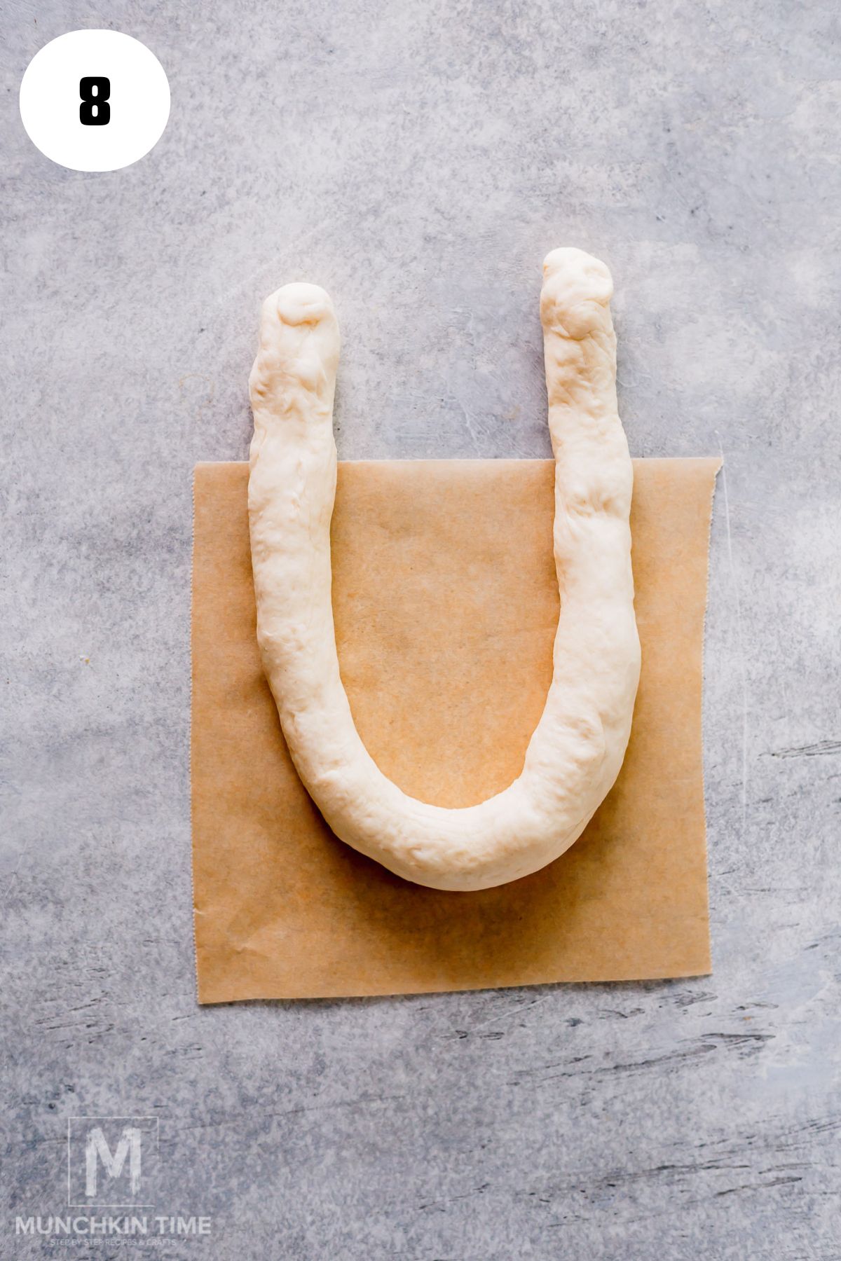a long strip of dough formed an u shape.