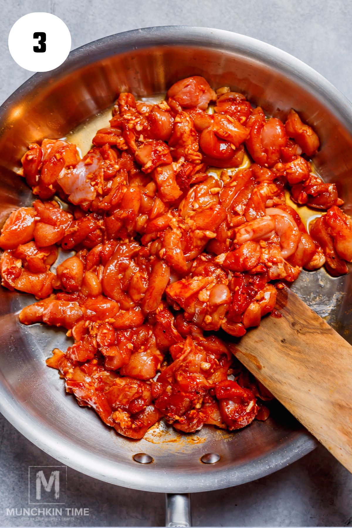 marinated chicken thighs pieces cooking in the skillet.