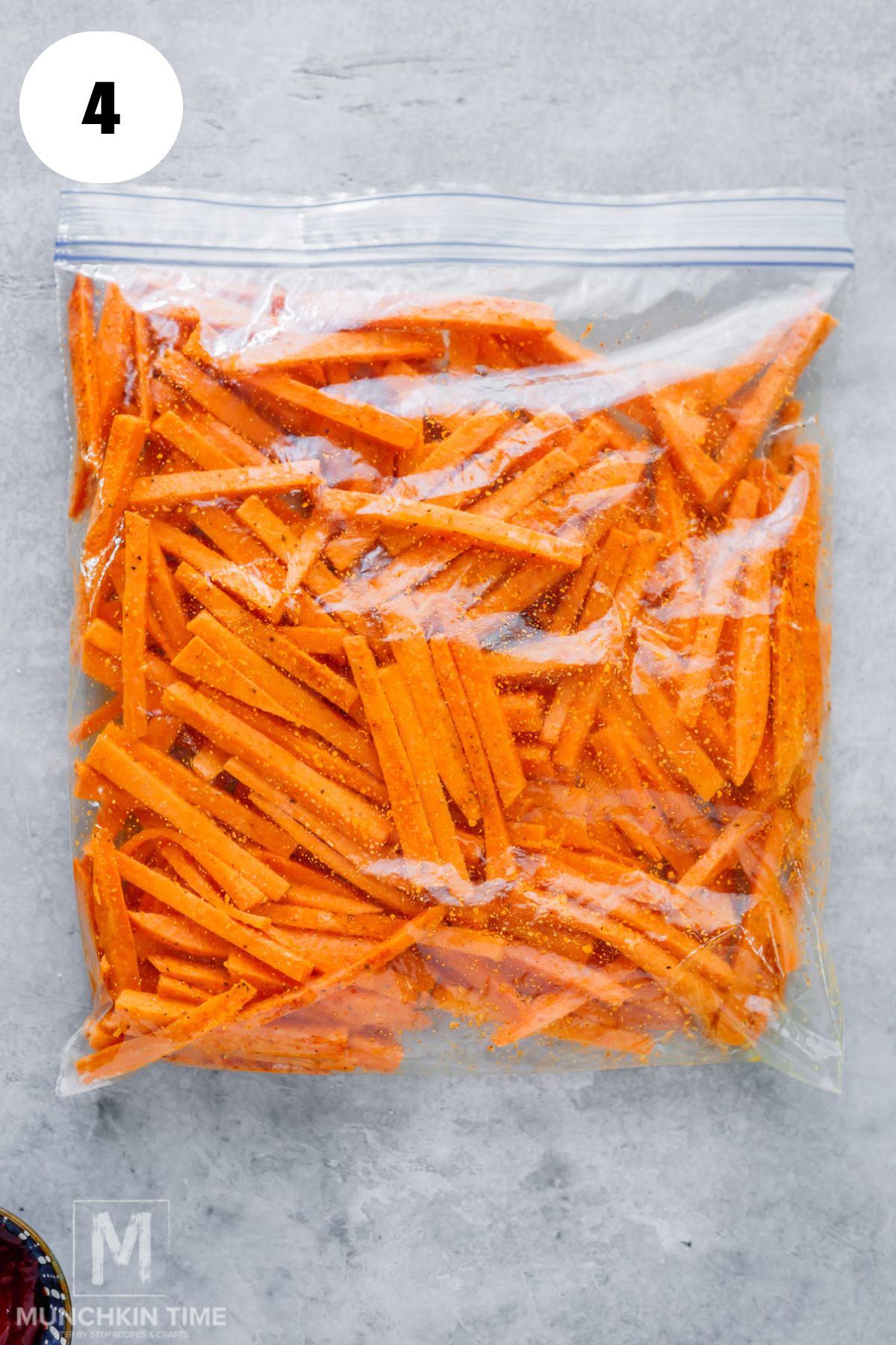 sweet potato fries mixed with spices in the zip bag ready for baking.