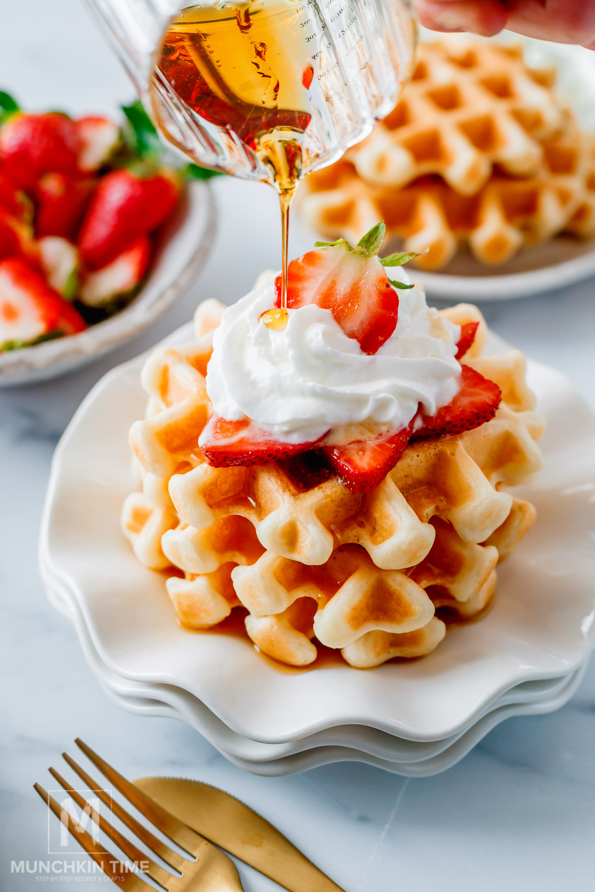 Maple syrup pouring over the Crispy Sourdough Waffles (Easy Discard or Active Starter Recipe)