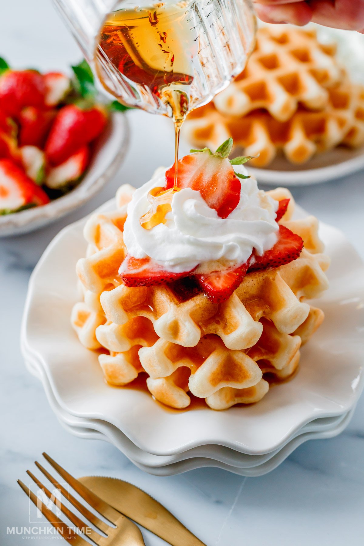 Maple syrup pouring over the Crispy Sourdough Waffles (Easy Discard or Active Starter Recipe)