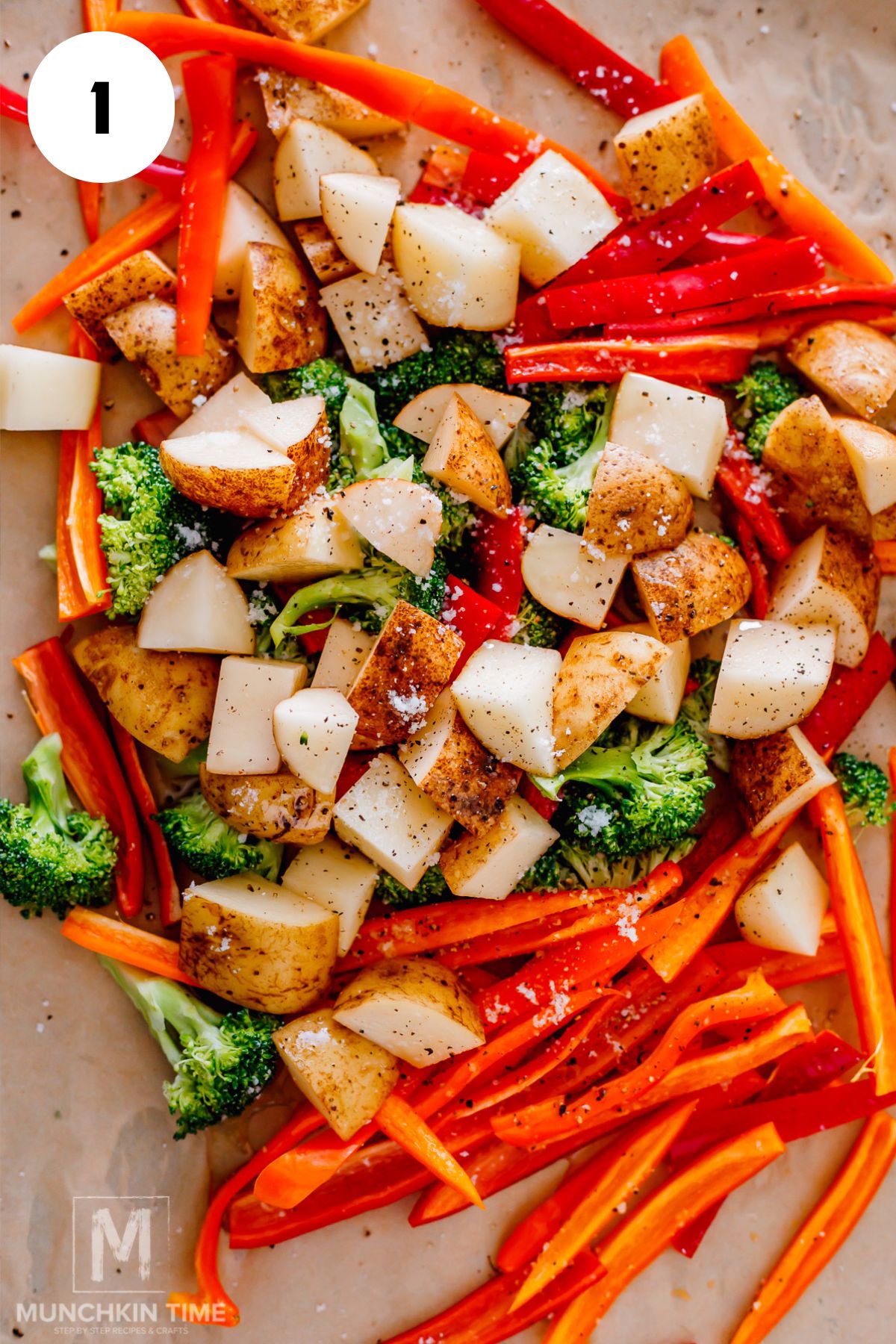 On a top of baking sheet lined with parchment paper, tossed broccoli with bell peppers and potatoes in oil, salt, and pepper.