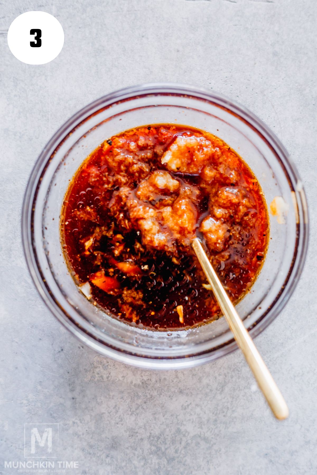 sauce ingredients which are honey, garlic and soy sauce in a bowl.