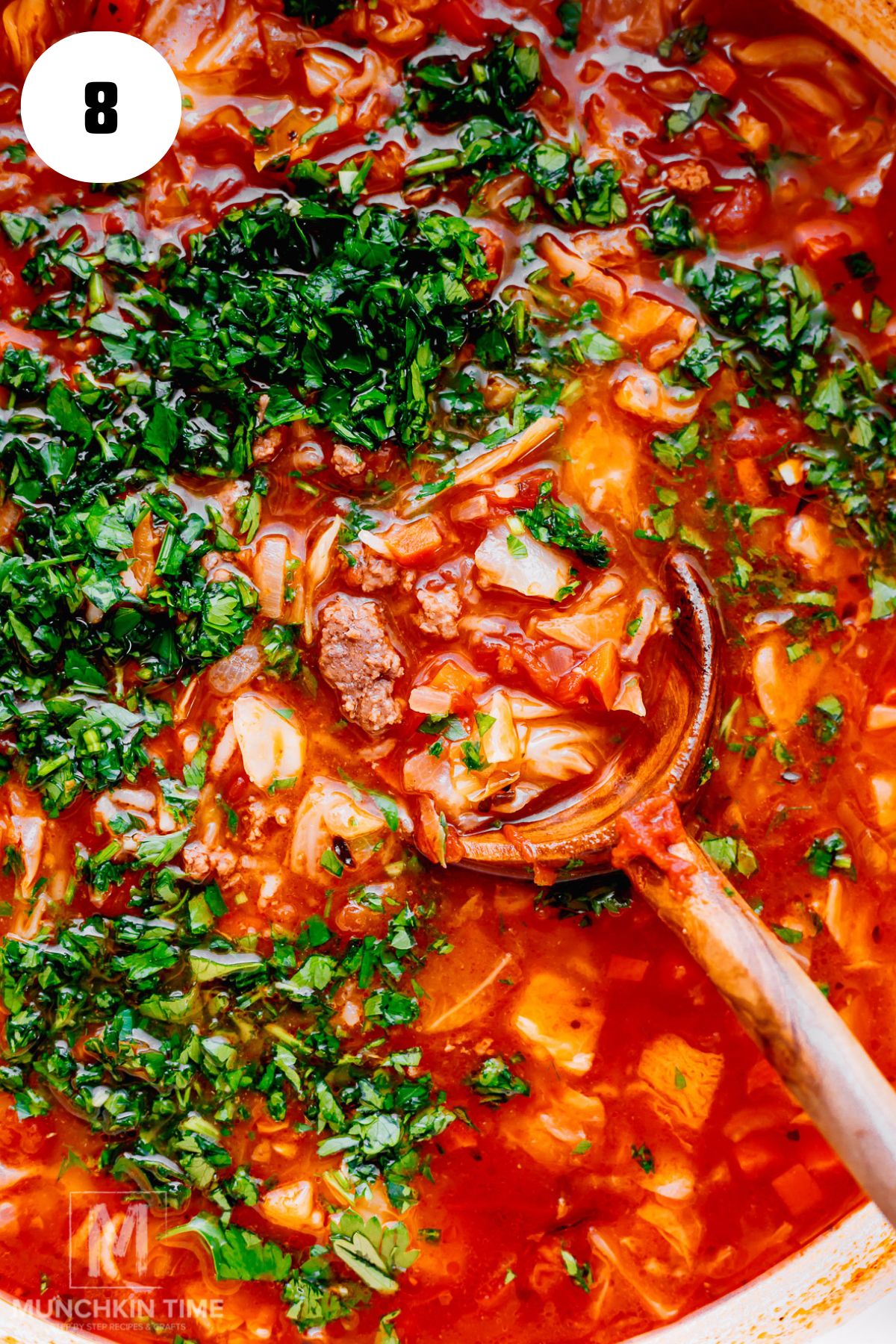 a close up of the finished cabbage roll soup with ground beef. Garnished with parsley.