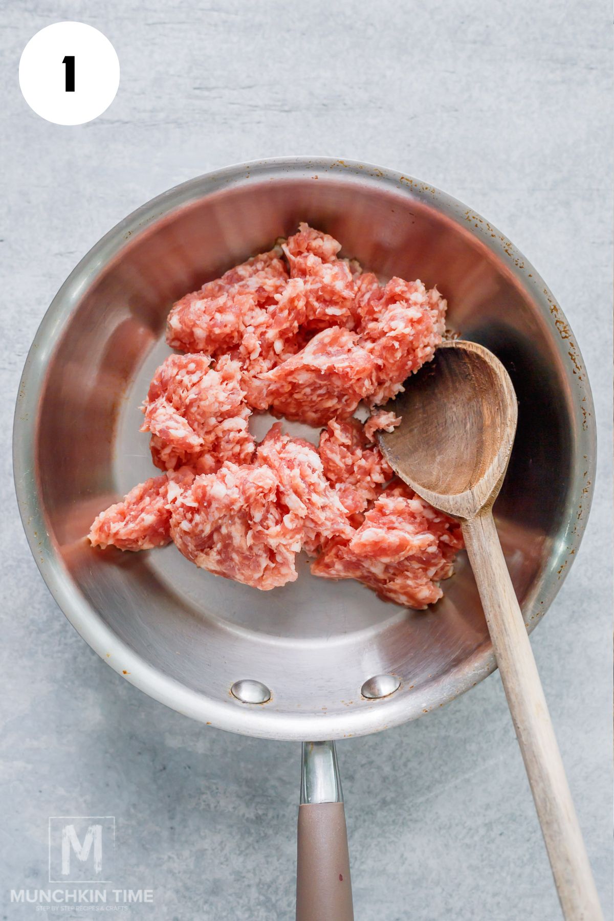 breakfast sausage added to the stainless steel skillet.