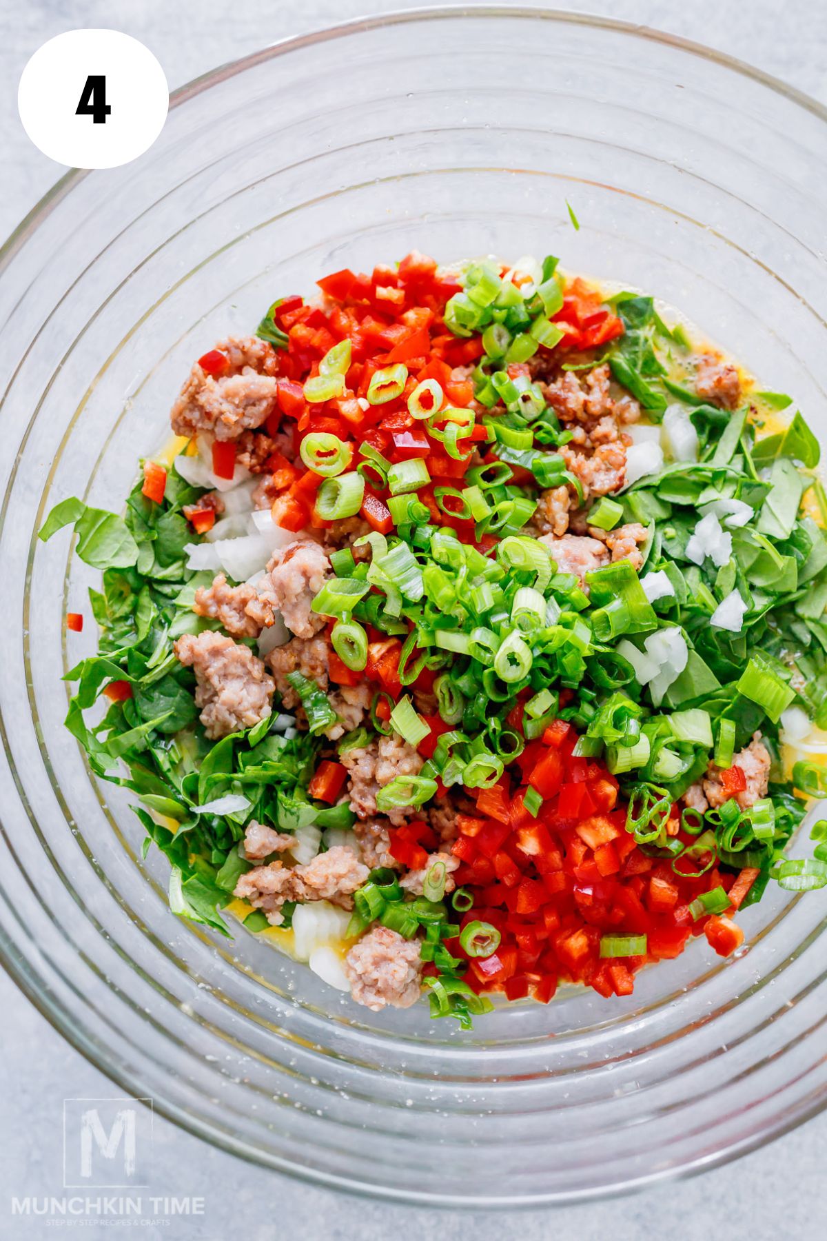 bell pepper, green onion, breakfast sausage and spinach added to the egg mixture.
