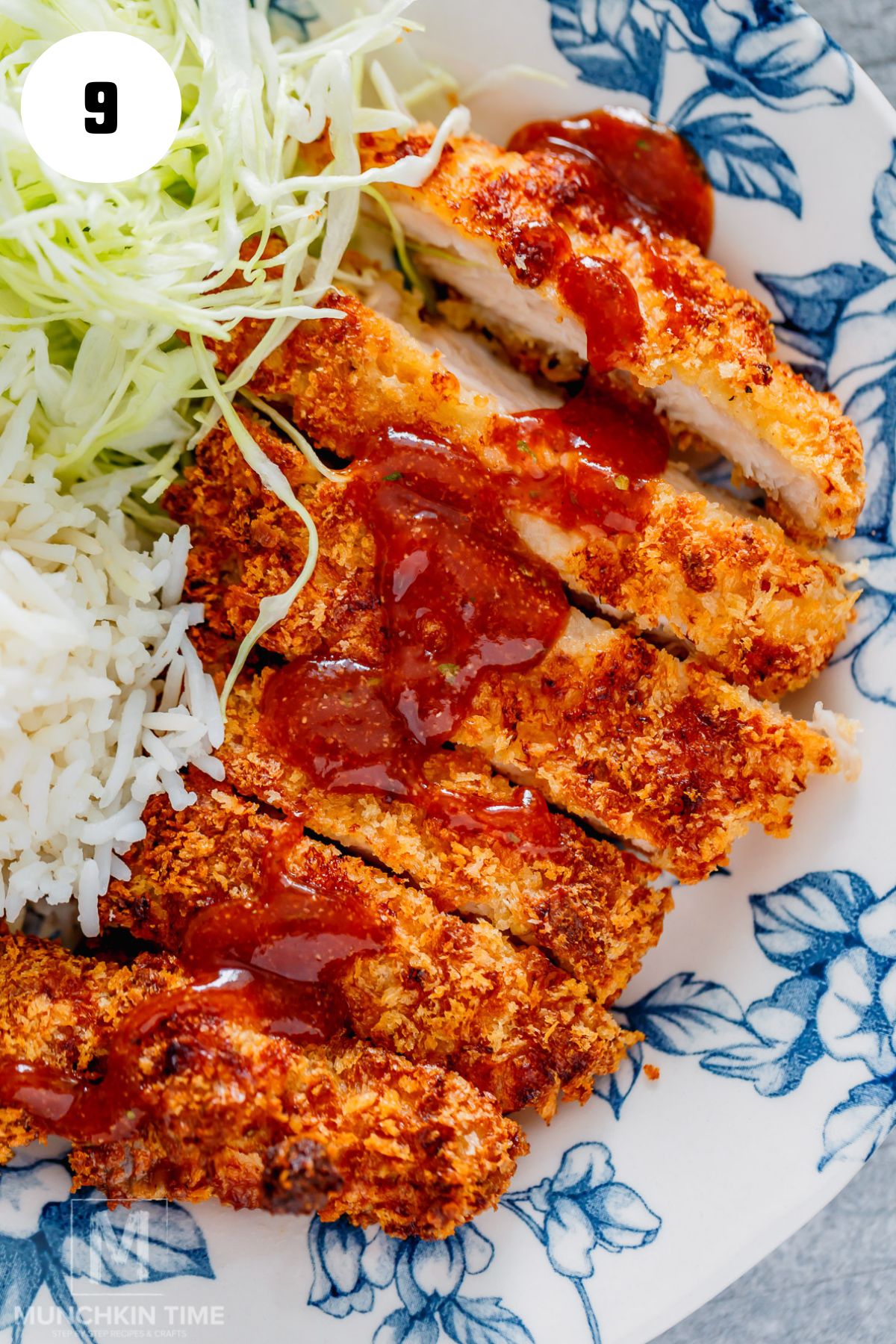 sliced air fryer chicken katsu with sauce on top.