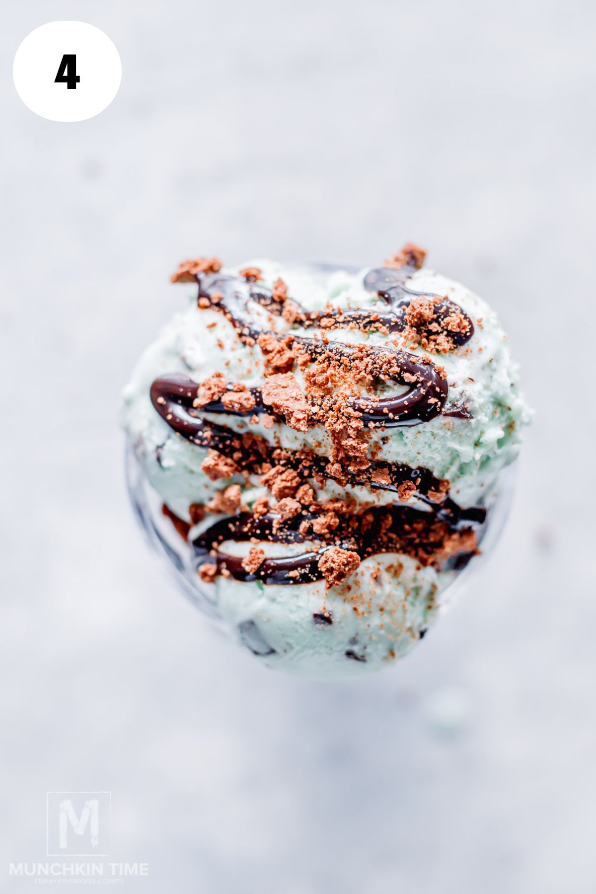 Chocolate syrup drizzle and chocolate cookie crumble sprinkled over Costco inspired Double Chocolate Mint Sundae