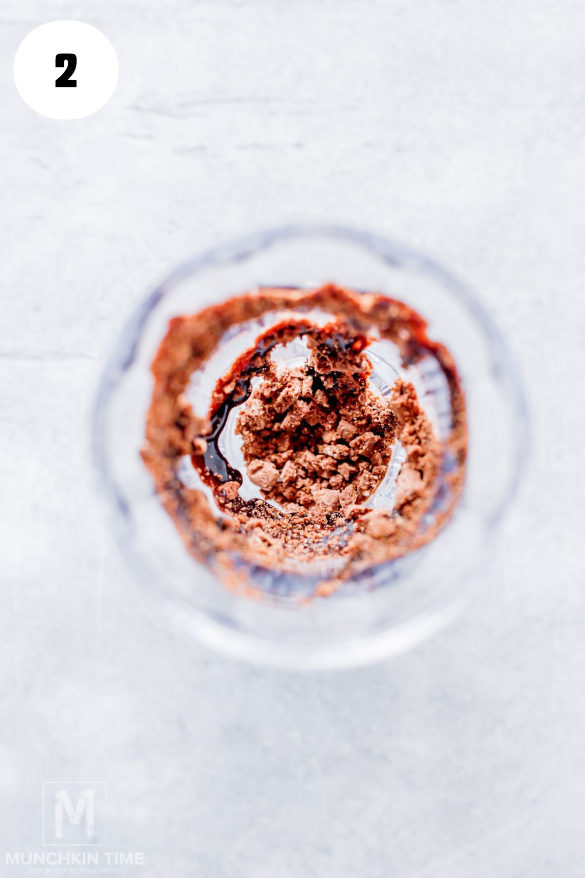 crumble cookies and chocolate syrup in a tall sundae cup.