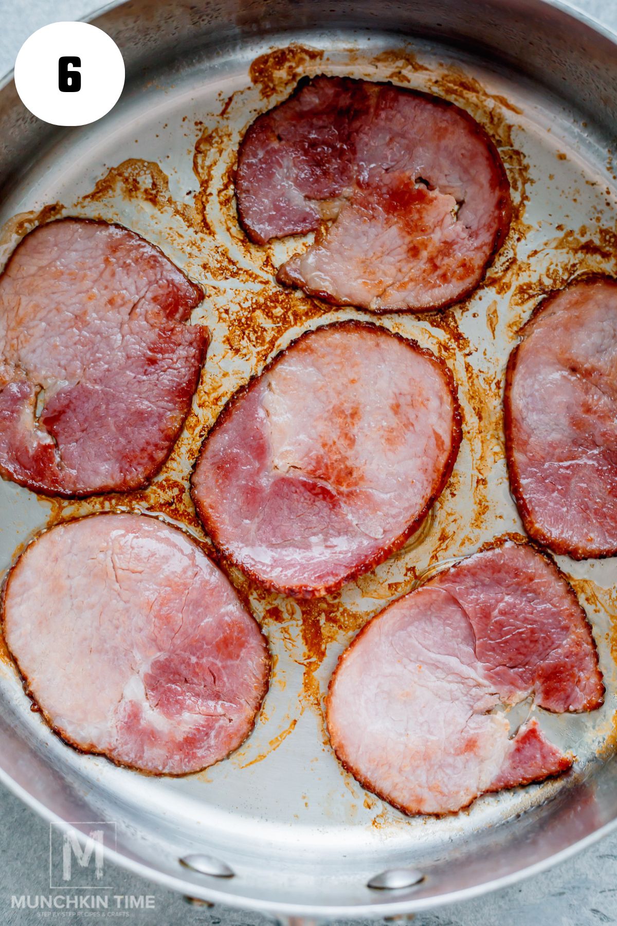 Canadian bacon browning in the skillet.