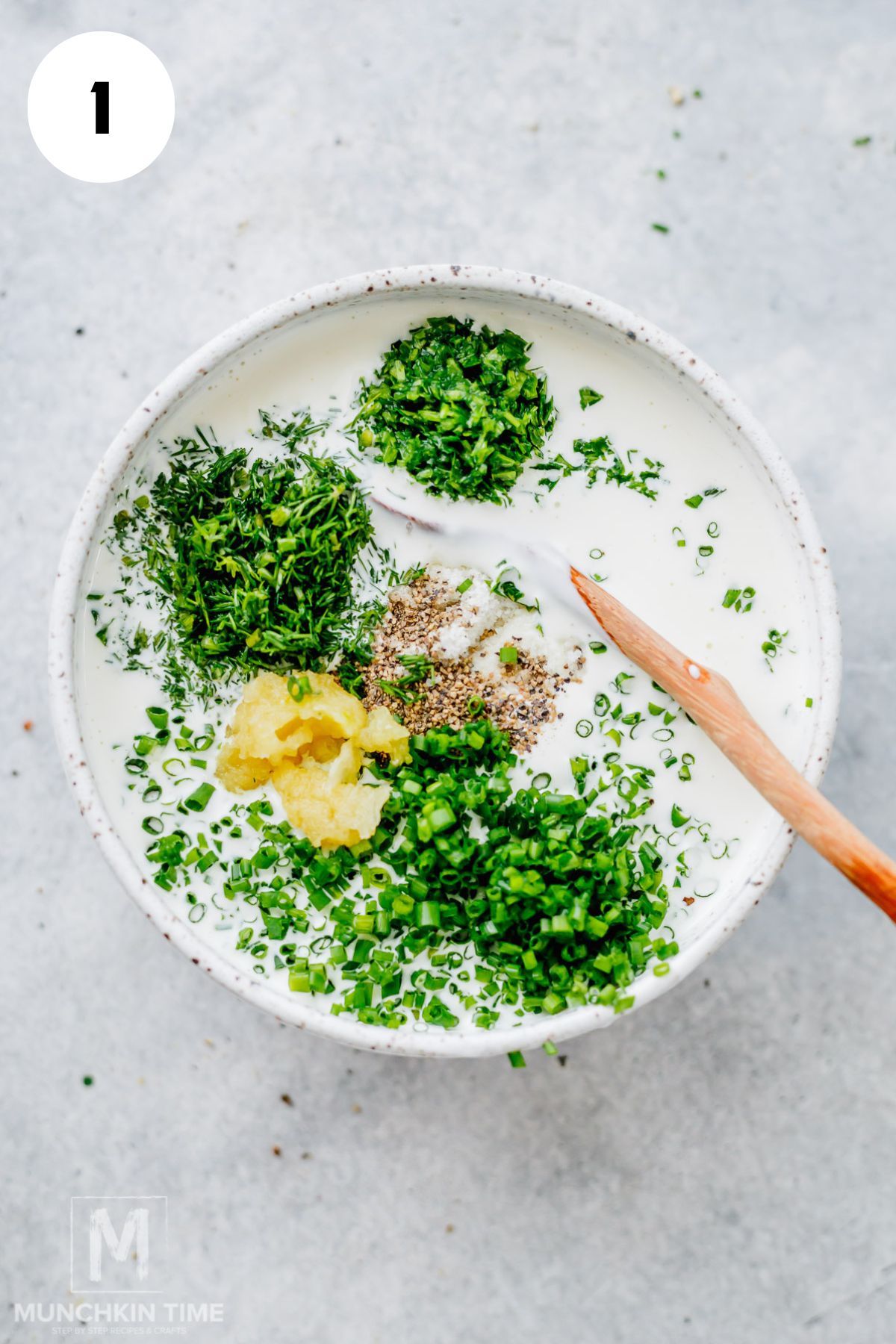 Whisking buttermilk, mayonnaise, and sour cream together in a bowl to make homemade ranch dressing.