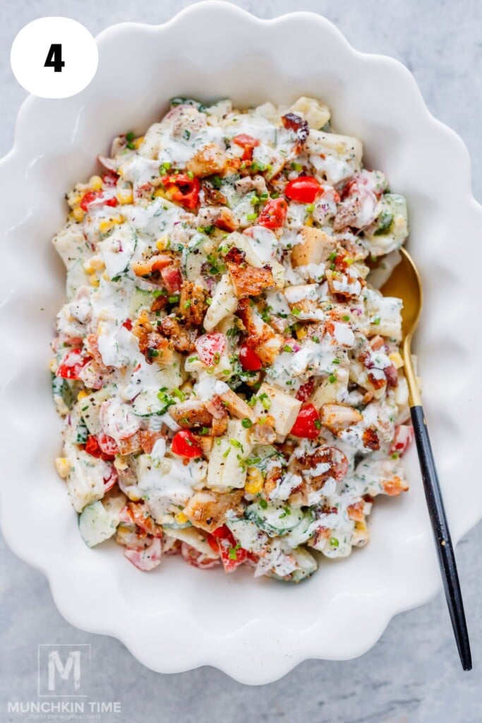 Freshly mixed Chicken Bacon Ranch Pasta Salad ready to chill before serving.