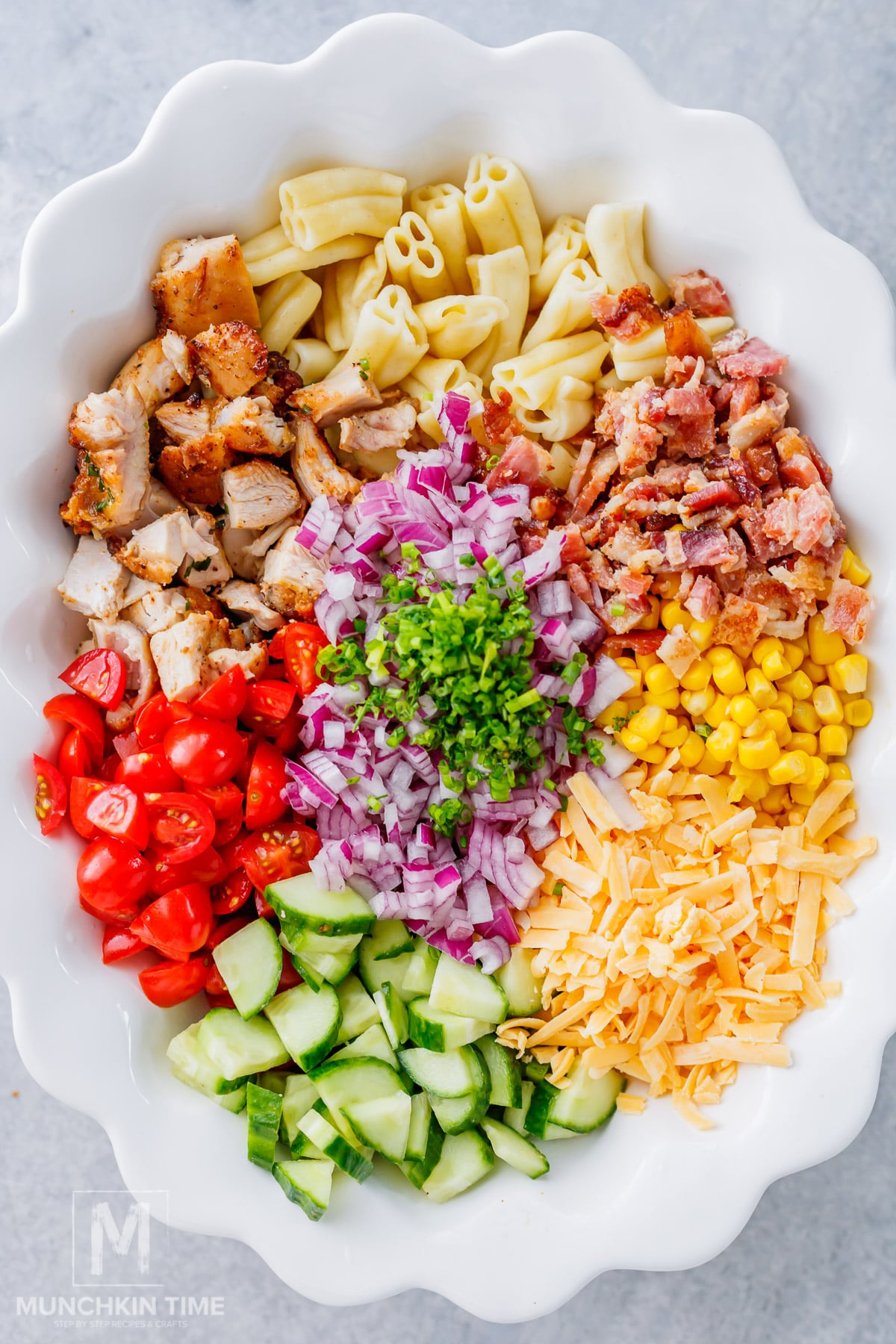 Pasta Salad made with chicken, bacon, cheddar cheese, corn, and fresh vegetables.