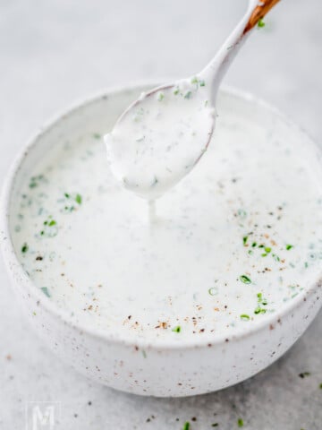 Creamy homemade ranch dressing with fresh herbs served in a small bowl.