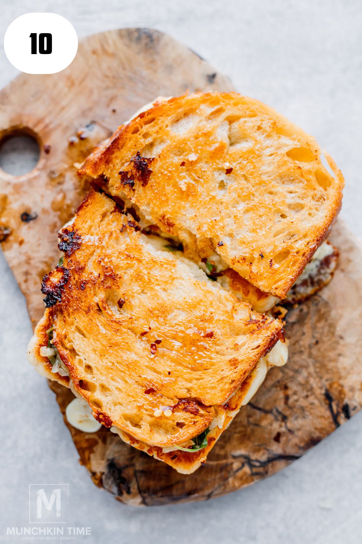 Close-up of a sliced hot honey halloumi grilled cheese with melted mozzarella.
