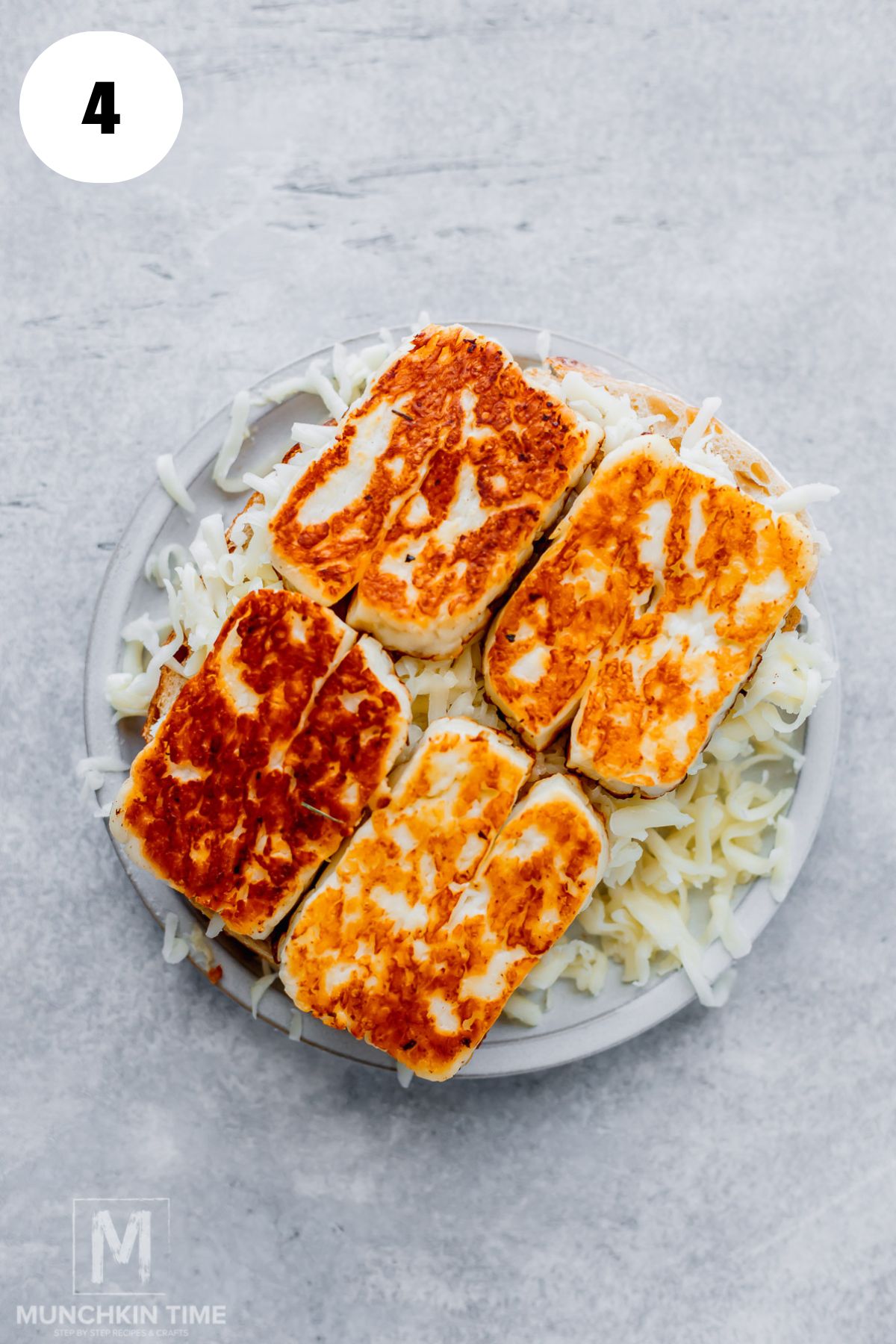 Shredded mozzarella layered on sourdough bread for grilled cheese, Golden fried halloumi layered over mozzarella on sourdough bread.