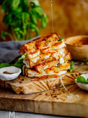 That crispy sourdough, salty golden halloumi, gooey mozzarella, and drizzle of hot honey make every bite of this grilled cheese completely irresistible.
