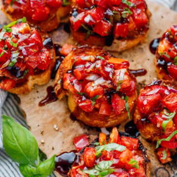 Close-up of homemade heirloom tomato bruschetta with fresh basil.