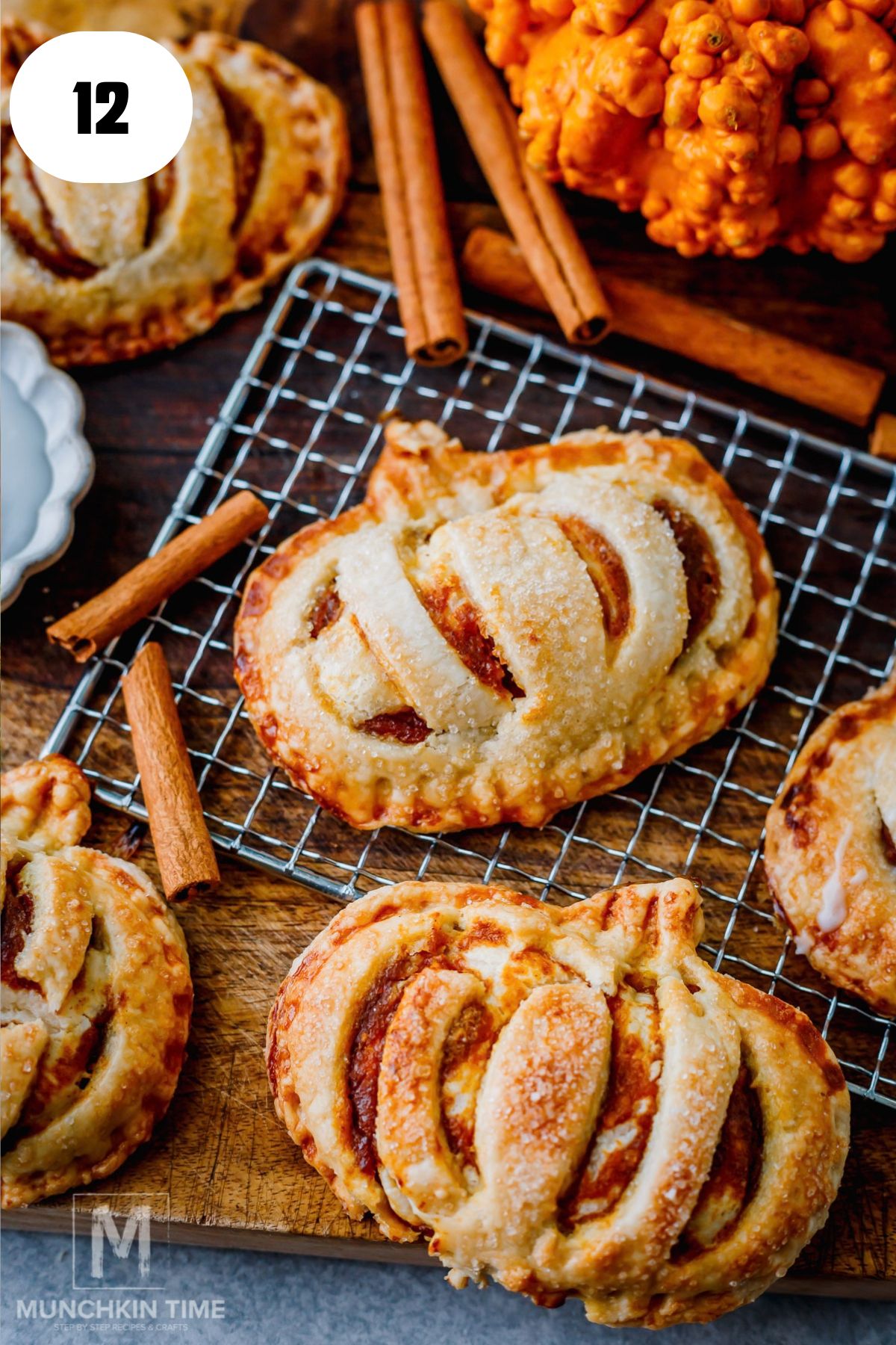 Golden baked pumpkin hand pies cooling on a baking sheet.