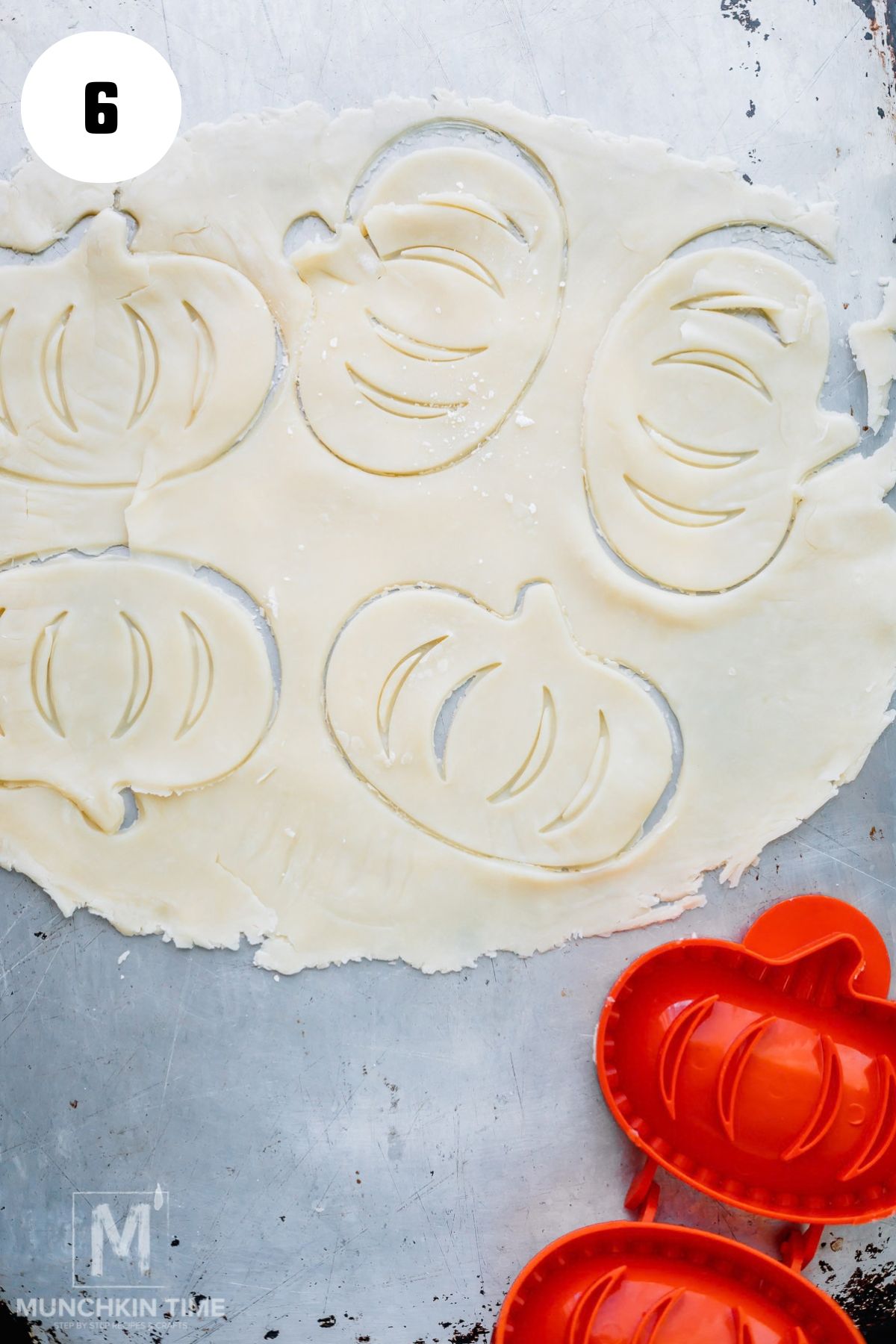 Cutting refrigerated pie crust with a pumpkin-shaped hand pie mold.