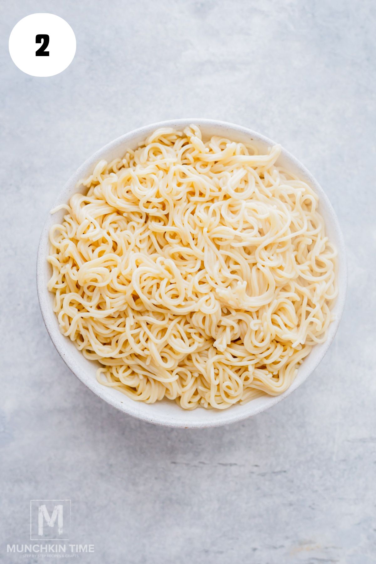 Cooked lo mein noodles tossed with sesame oil.
