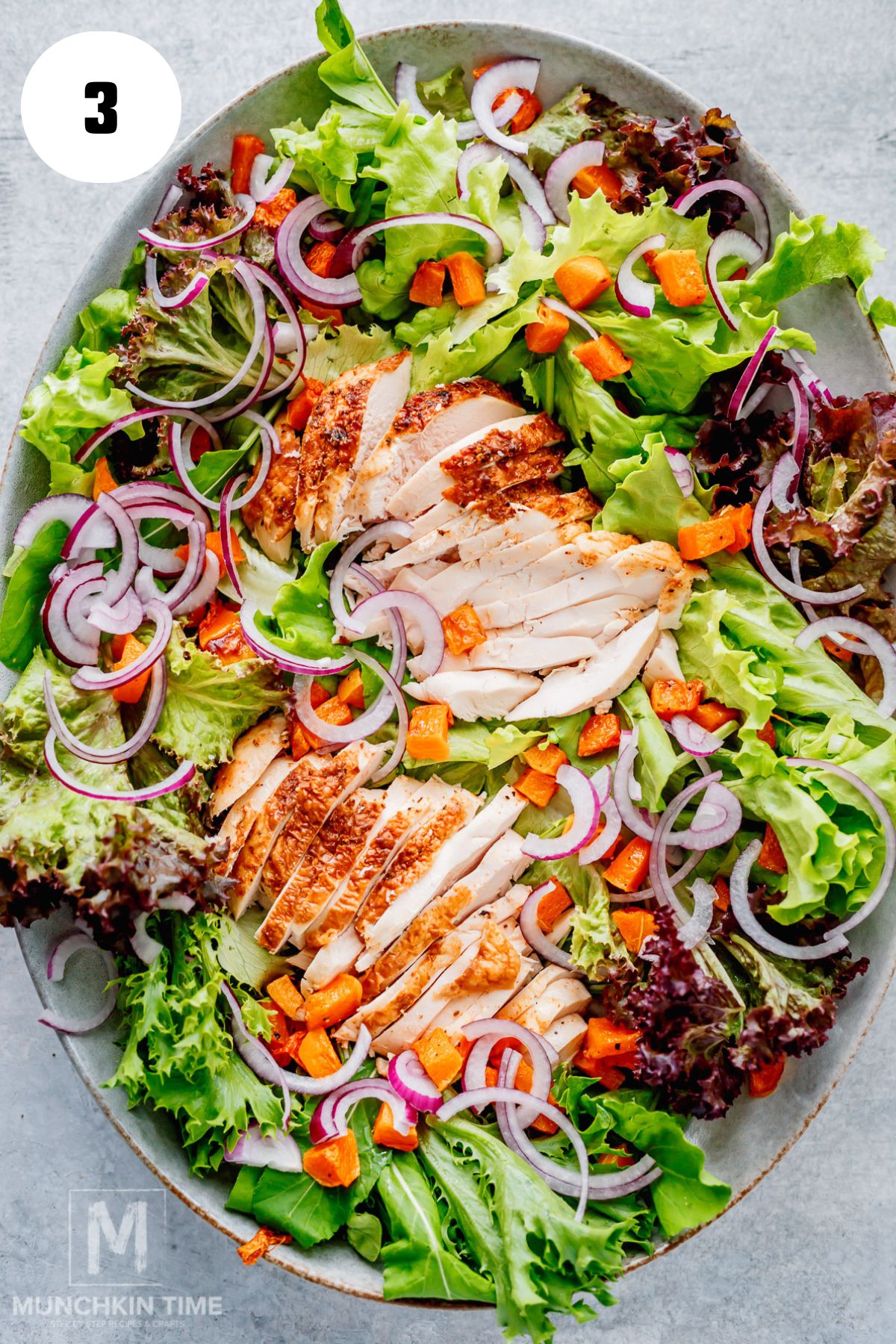 Mixed greens topped with rotisserie chicken, roasted butternut squash and red onion
