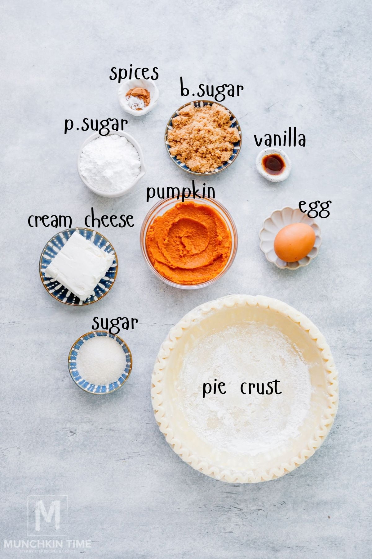 Ingredients for pumpkin cream cheese hand pies including pumpkin puree, cream cheese, pie crust, brown sugar, pumpkin pie spice, vanilla, egg and powdered sugar.