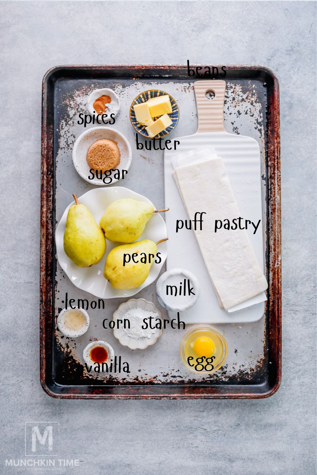 Ingredients for pear galette with puff pastry, fresh Bartlett pears, cinnamon, brown sugar, and butter.