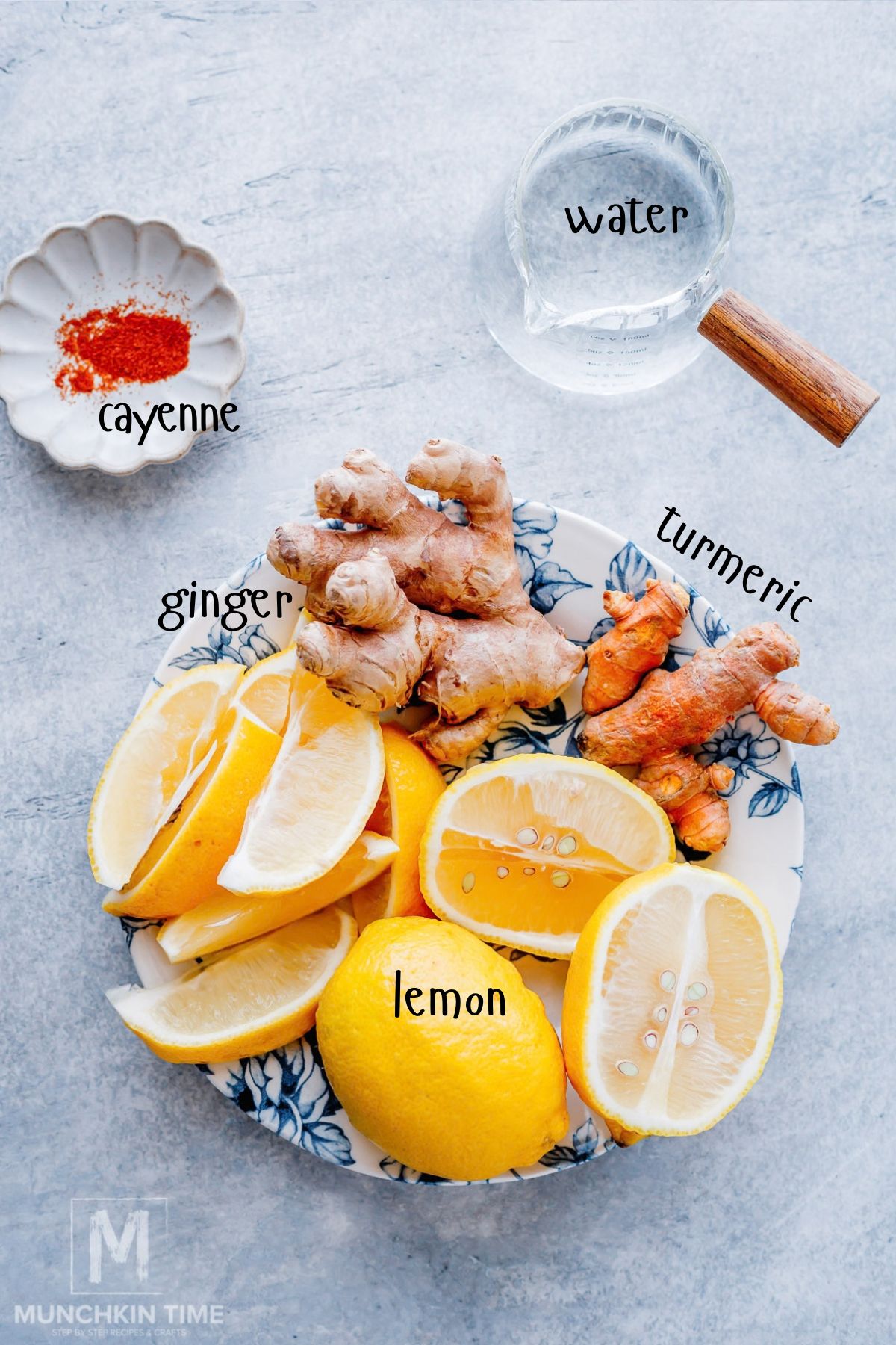 Ingredients for lemon ginger ice cubes including lemons, fresh ginger, turmeric and cayenne