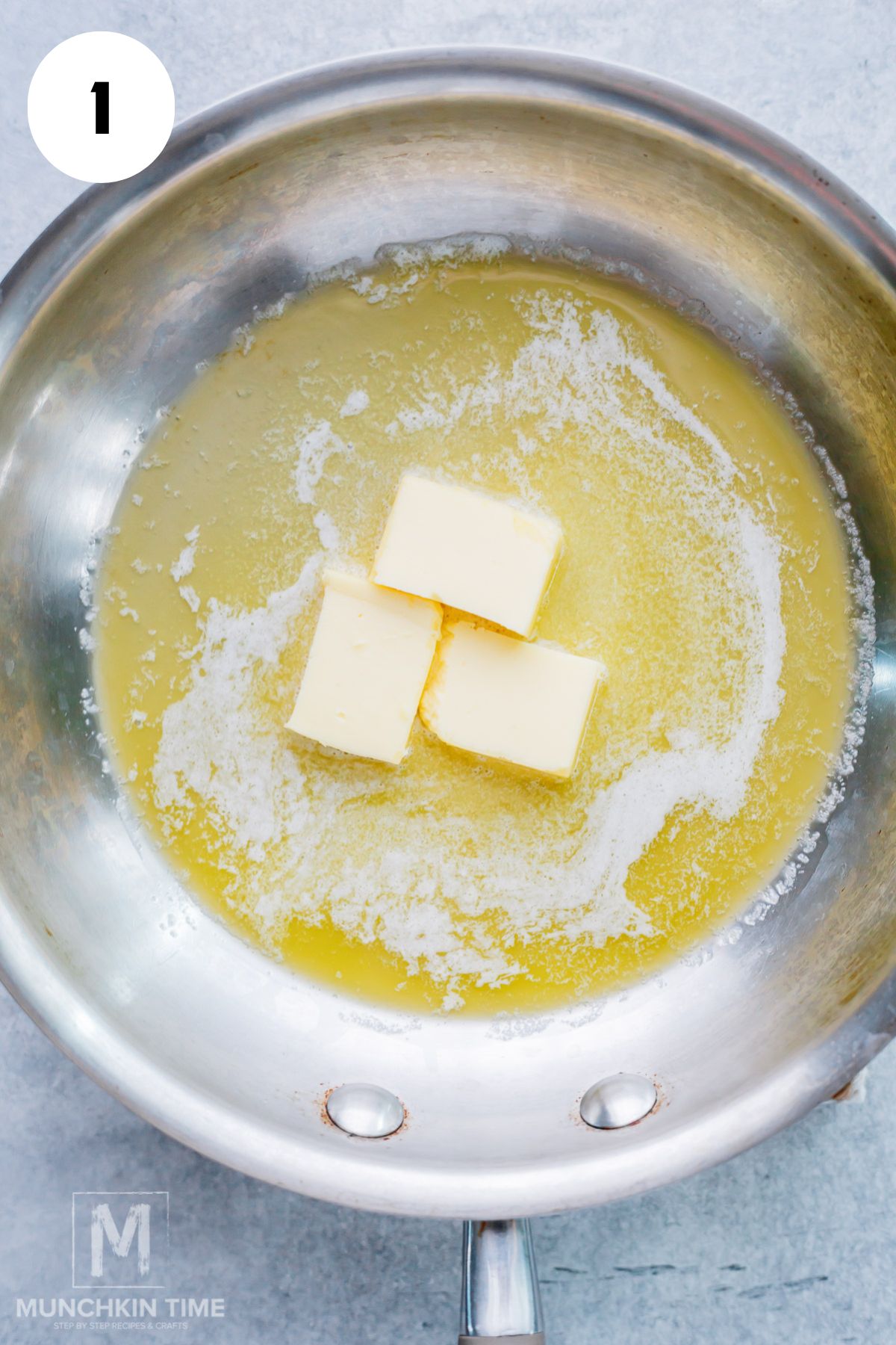 Unsalted butter browning in a saucepan until golden and nutty.