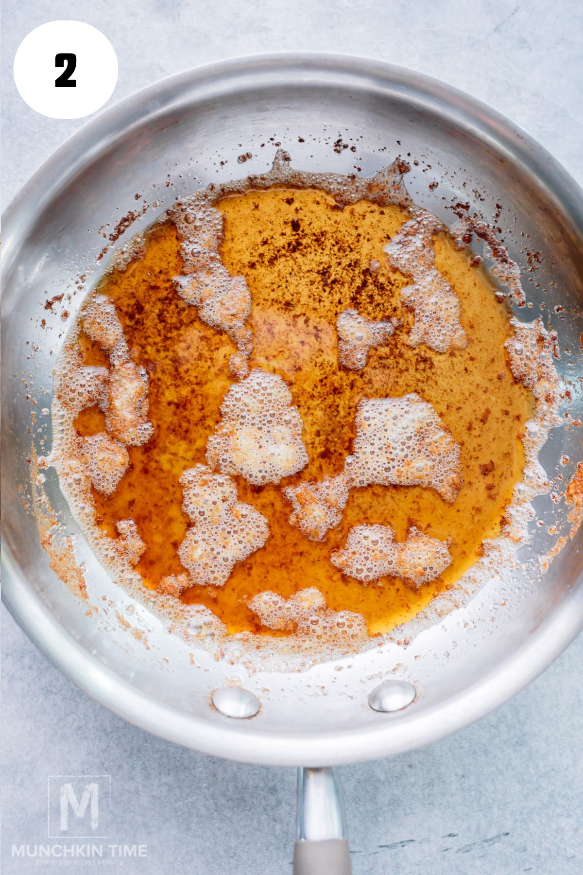 Unsalted butter browning in a saucepan until golden and nutty.