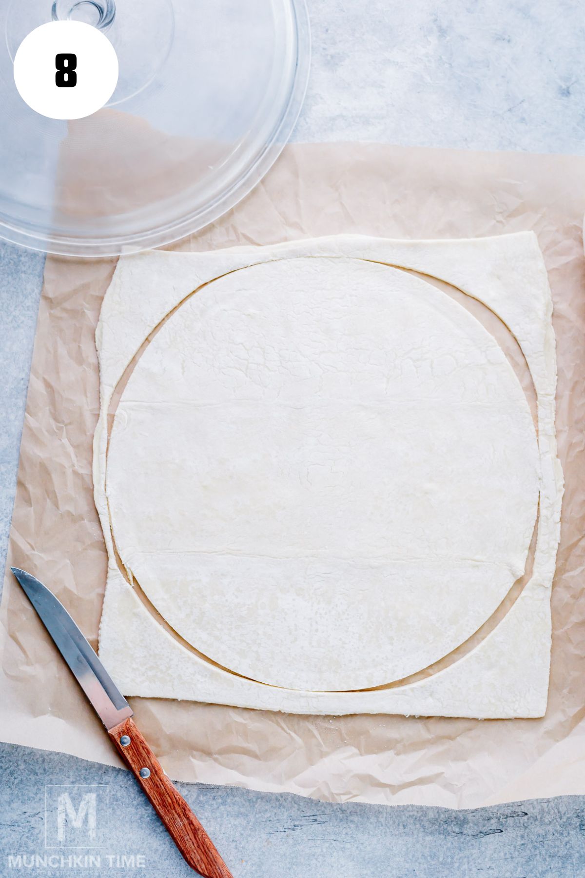 Store-bought puff pastry rolled into a circle on parchment paper.