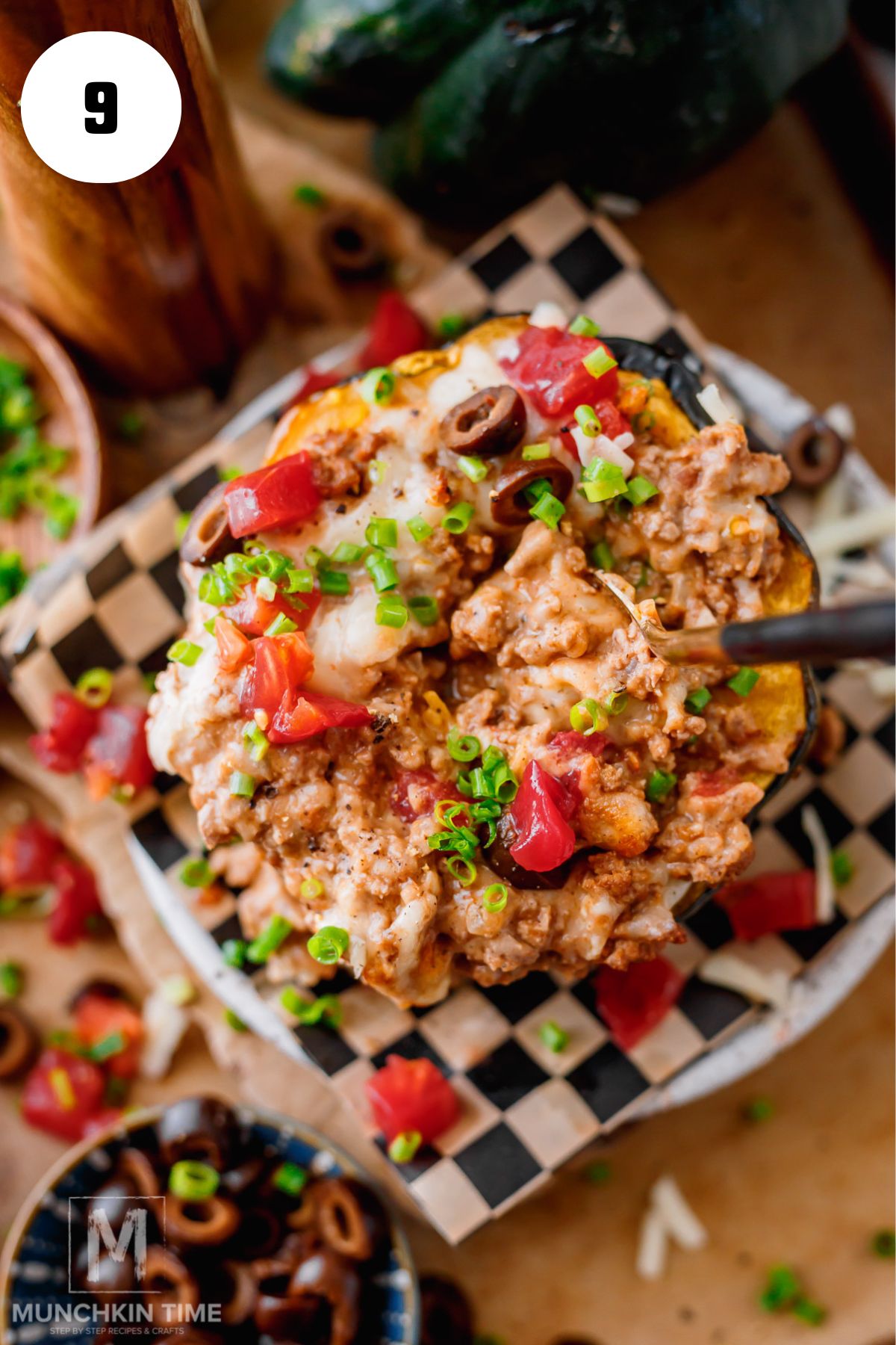 Stuffed acorn squash with ground beef topped with sour cream, diced tomatoes, avocado, and fresh cilantro
