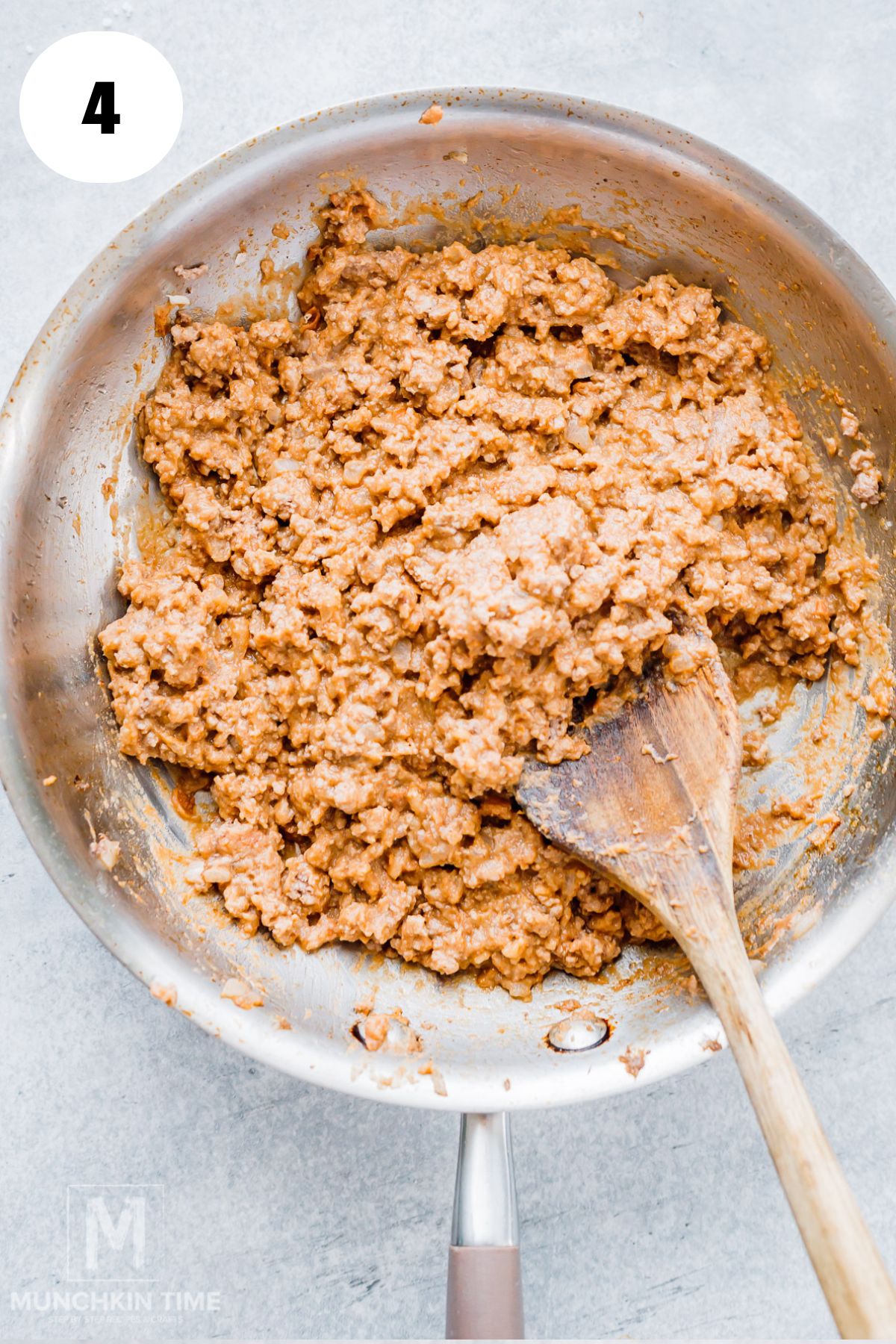 refried beans and taco seasoning into browned ground beef for acorn squash filling