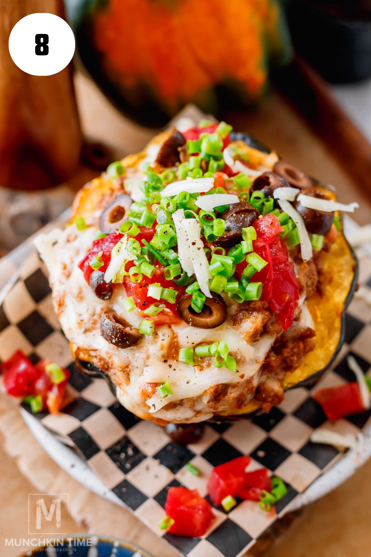 Cheesy ground beef stuffed acorn squash baking in the oven until golden and bubbly