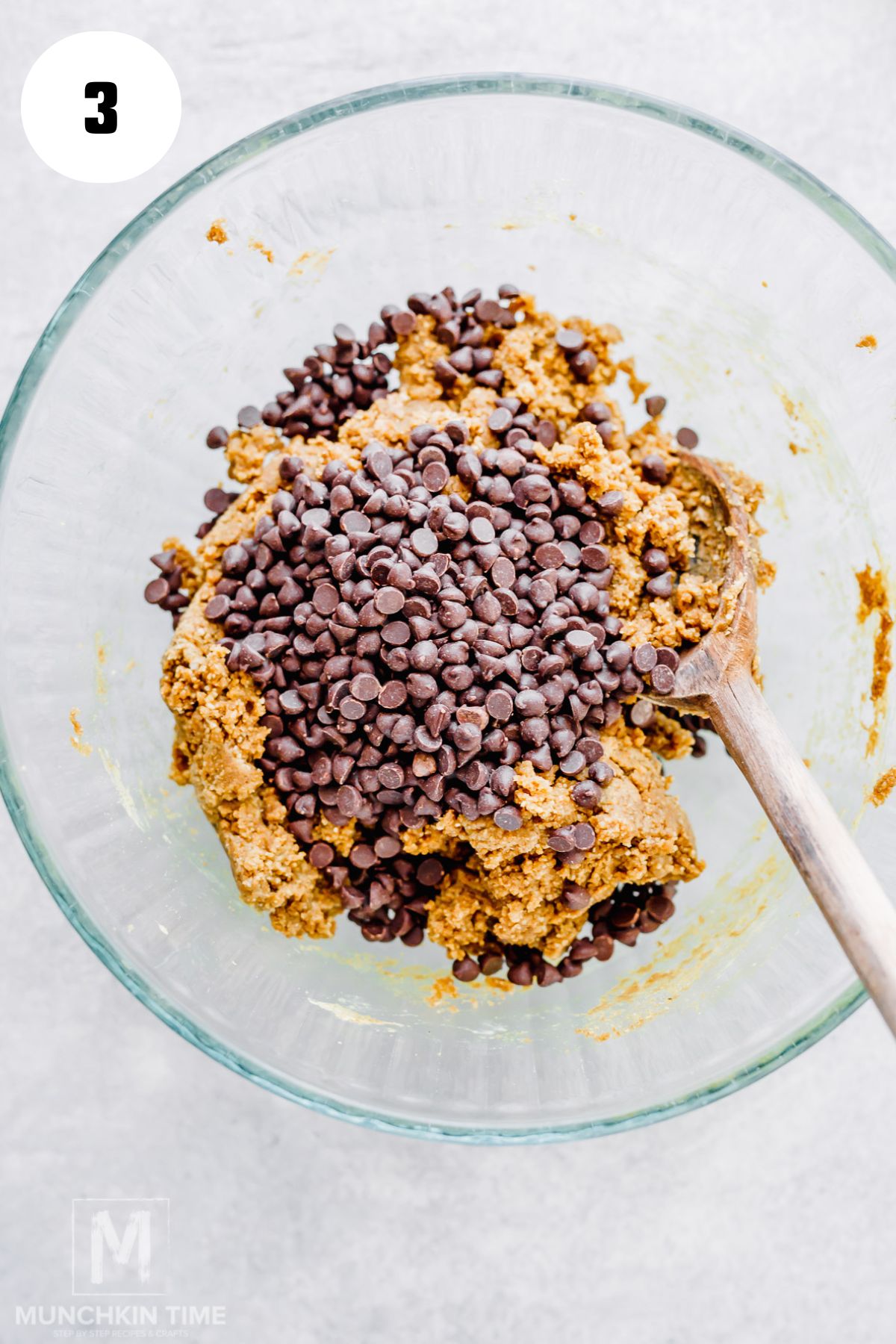 Folding mini dark chocolate chips into homemade protein cookie dough