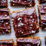 No-bake cookie dough protein bars with date caramel and dark chocolate topping