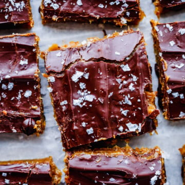 No-bake cookie dough protein bars with date caramel and dark chocolate topping