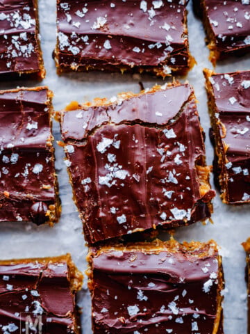 No-bake cookie dough protein bars with date caramel and dark chocolate topping