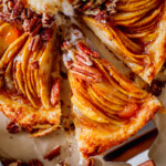 Pear galette with puff pastry served with vanilla bean ice cream, caramel drizzle, and crunchy pecans.