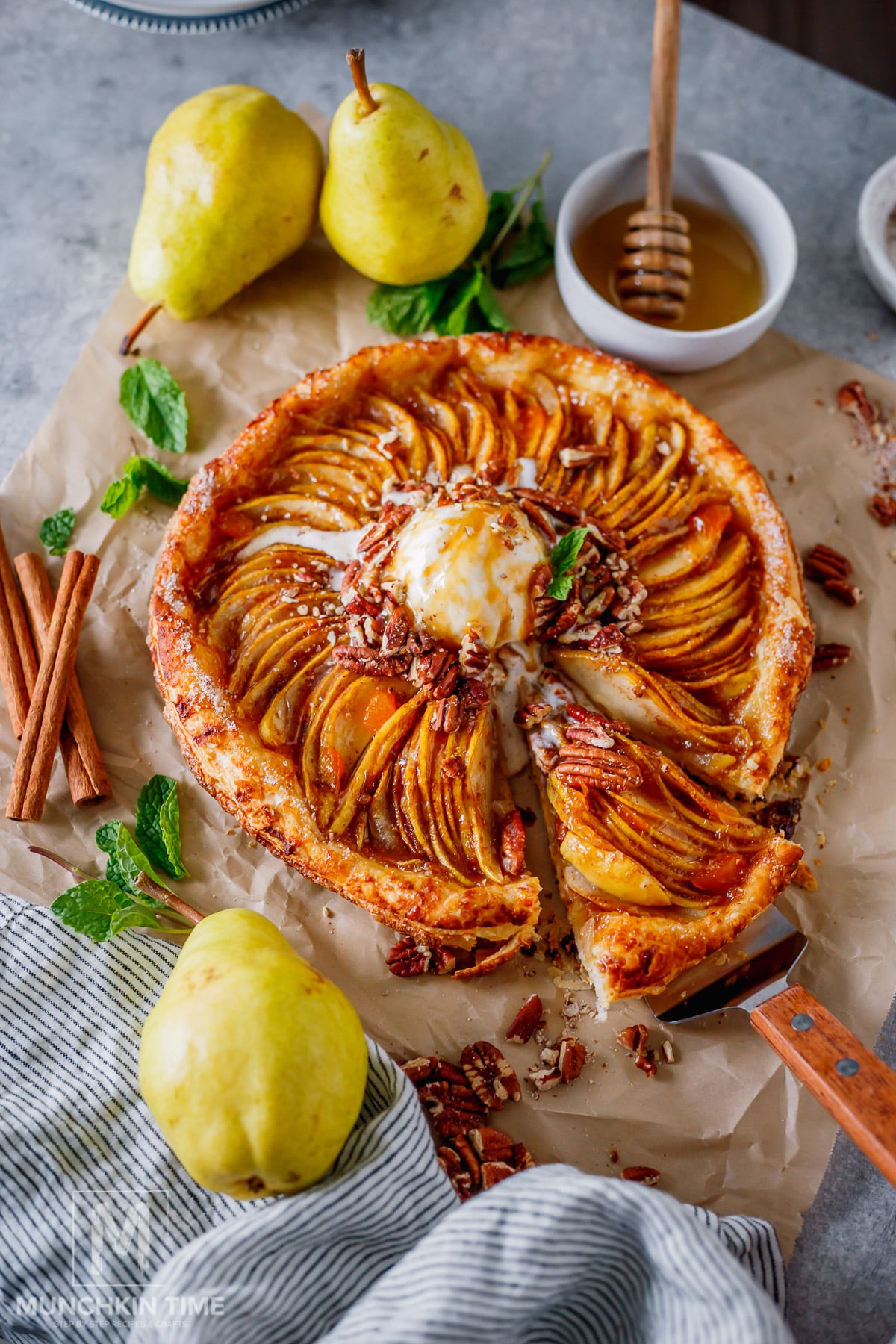 Homemade pear galette with golden puff pastry crust and overlapping Bartlett pear slices.